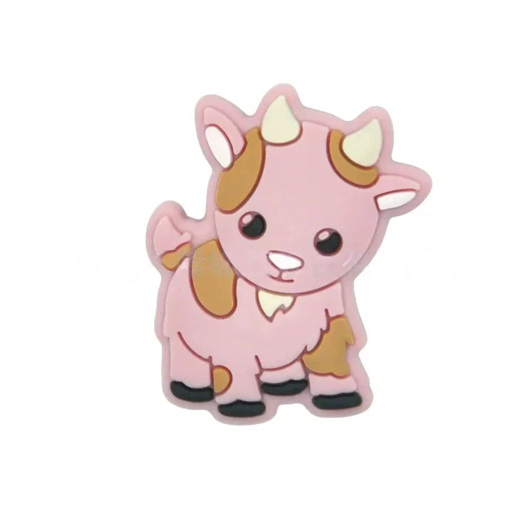Assorted pastel color cute cow silicone focal beads displayed on a white shell dish and strung on a white cord against a teal background, available in gray, green, pink, tan, and white colorways. - Pink