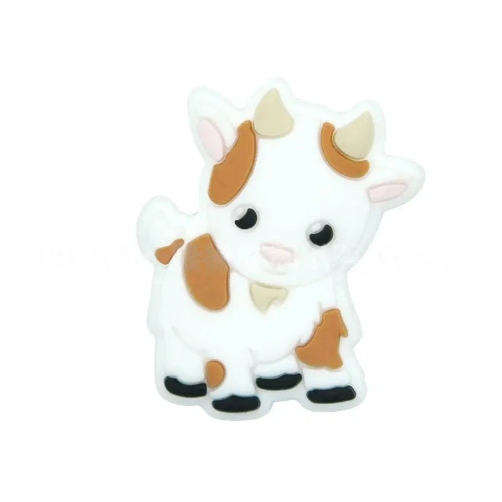 Assorted pastel color cute cow silicone focal beads displayed on a white shell dish and strung on a white cord against a teal background, available in gray, green, pink, tan, and white colorways. - White