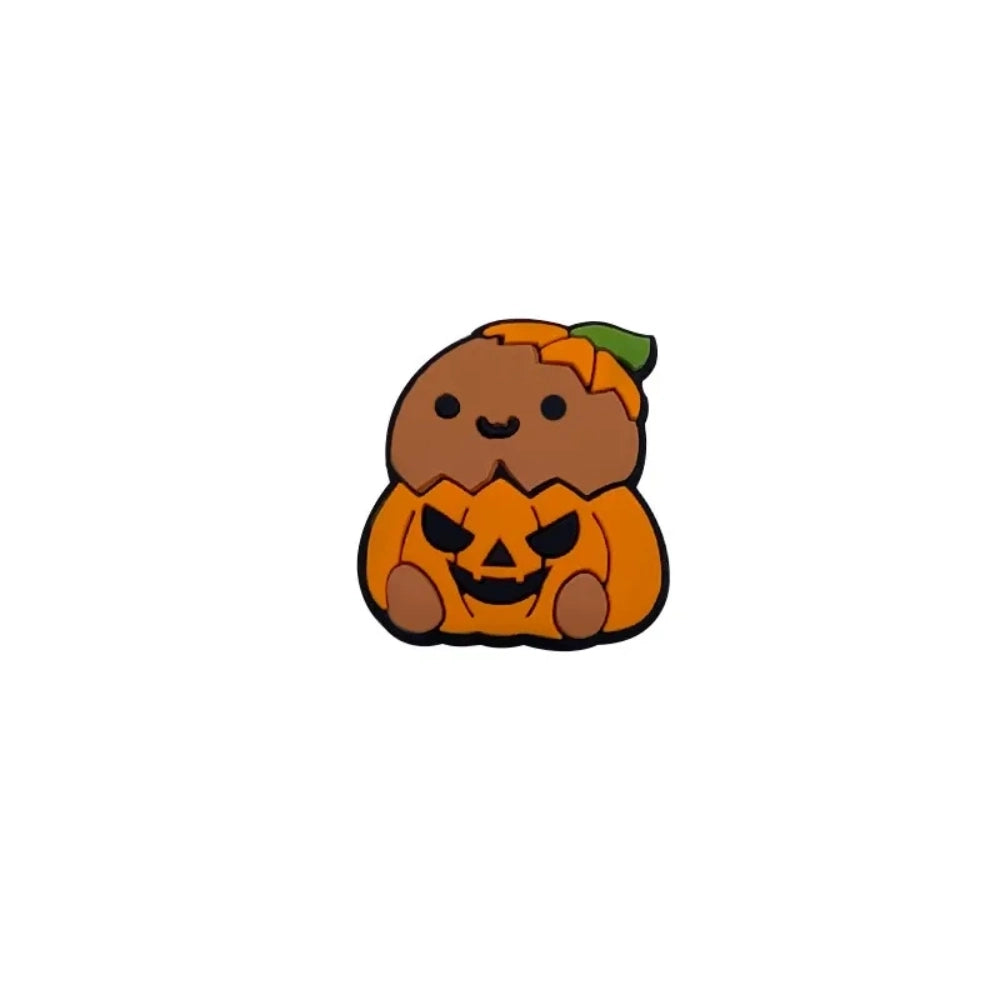 Four cute silicone focal beads featuring cartoon critters sitting inside jack-o-lantern pumpkin costumes, available in light and brown character skin tones, displayed on a white platform with a warm beige background. - Camel