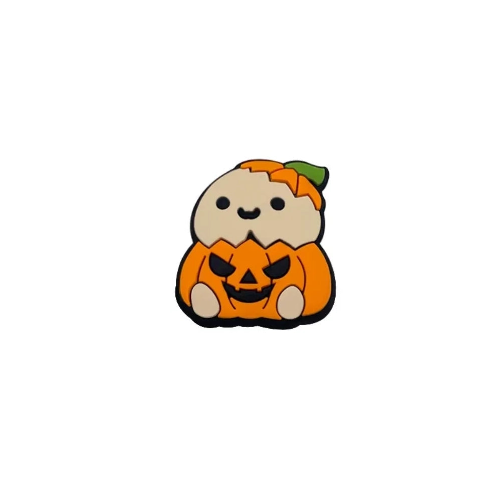Four cute silicone focal beads featuring cartoon critters sitting inside jack-o-lantern pumpkin costumes, available in light and brown character skin tones, displayed on a white platform with a warm beige background. - Creamy White