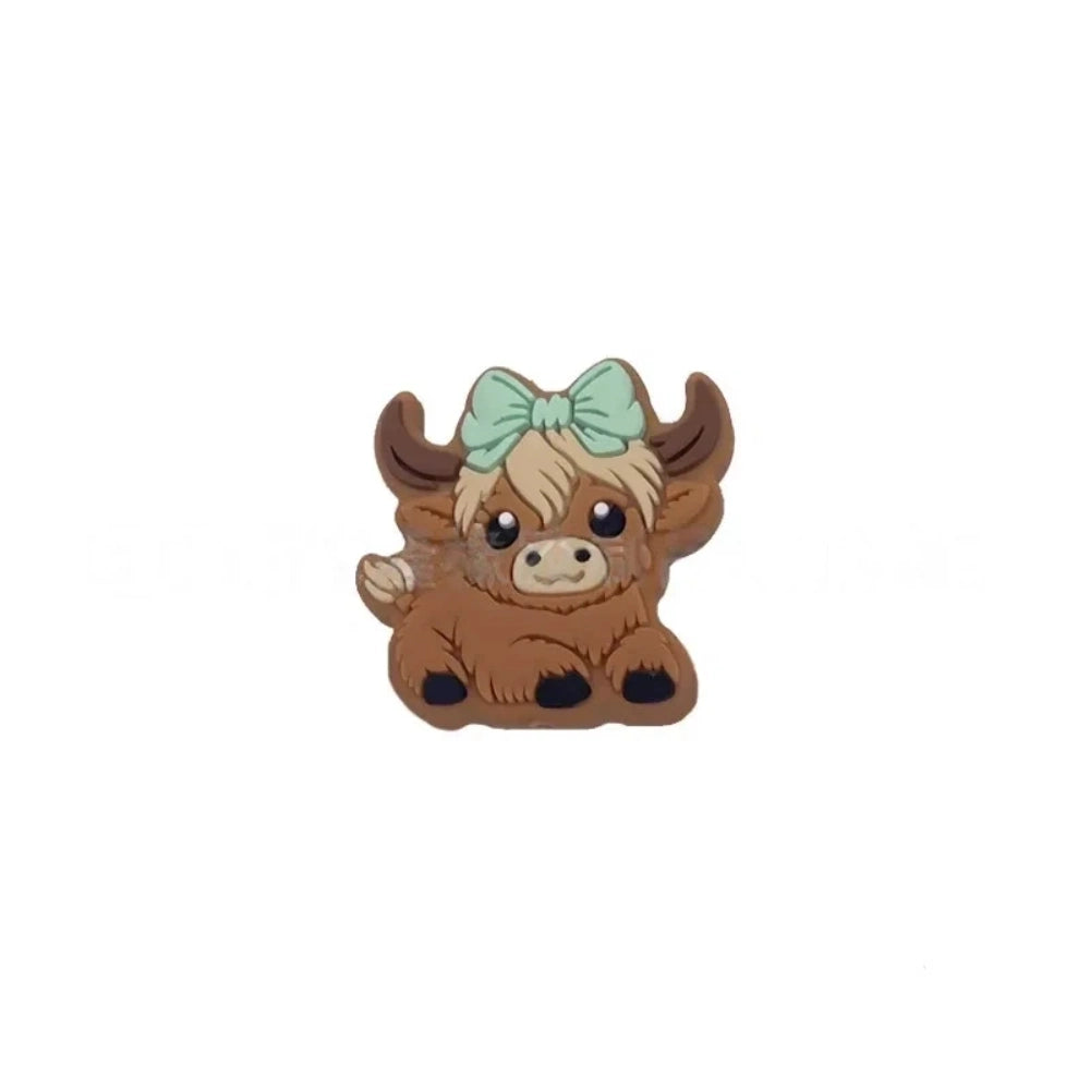 Six silicone Highland cow focal beads in brown – three wearing colorful baseball caps (blue, teal, gray) and three with bow accessories (mint, purple, pink) – crafting supplies for beadable pens, keychains, and badge reels. - Green-2