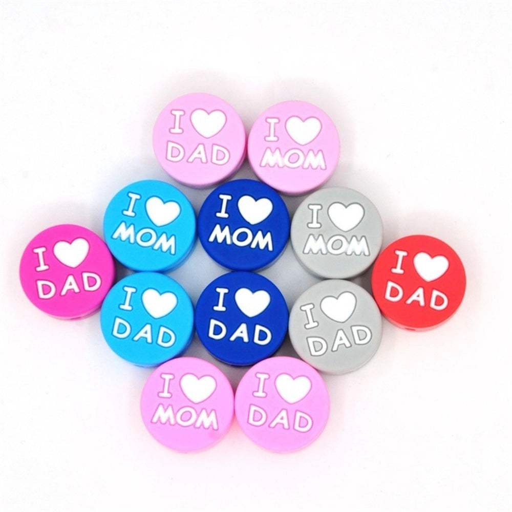 Assorted colorful round silicone focal beads with I Love Mom and I Love Dad heart text in pink, blue, navy, gray, hot pink, and red colors for DIY crafts.