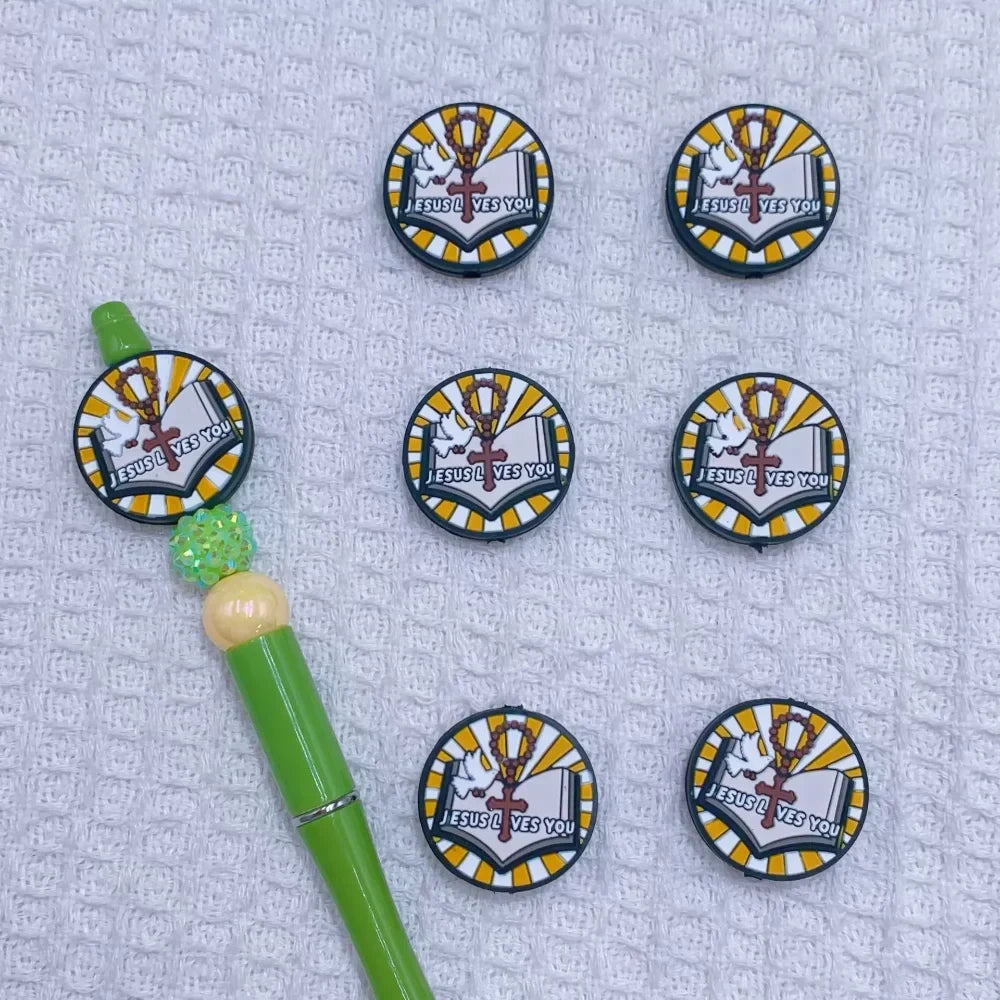 Silicone focal beads featuring Jesus Loves You round, Best Mom Ever star, and Live in the Sunshine heart designs displayed on beadable pens and scattered on a white plate, colorful DIY craft supplies from DIY Mini Planet. - 3