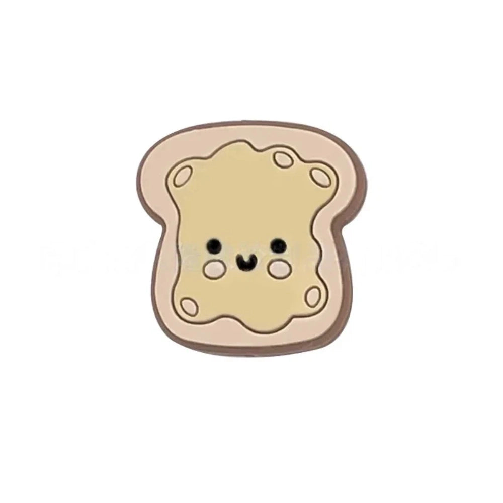 Five kawaii toast spread silicone focal beads in chocolate, pink jam, red jam, grape jam, and peanut butter designs, displayed on colorful beadable pens against a pink background. - Brown