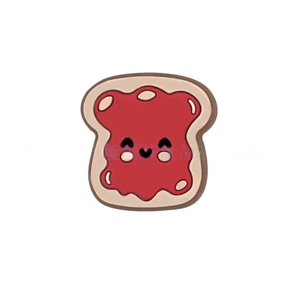 Five kawaii toast spread silicone focal beads in chocolate, pink jam, red jam, grape jam, and peanut butter designs, displayed on colorful beadable pens against a pink background. - Red