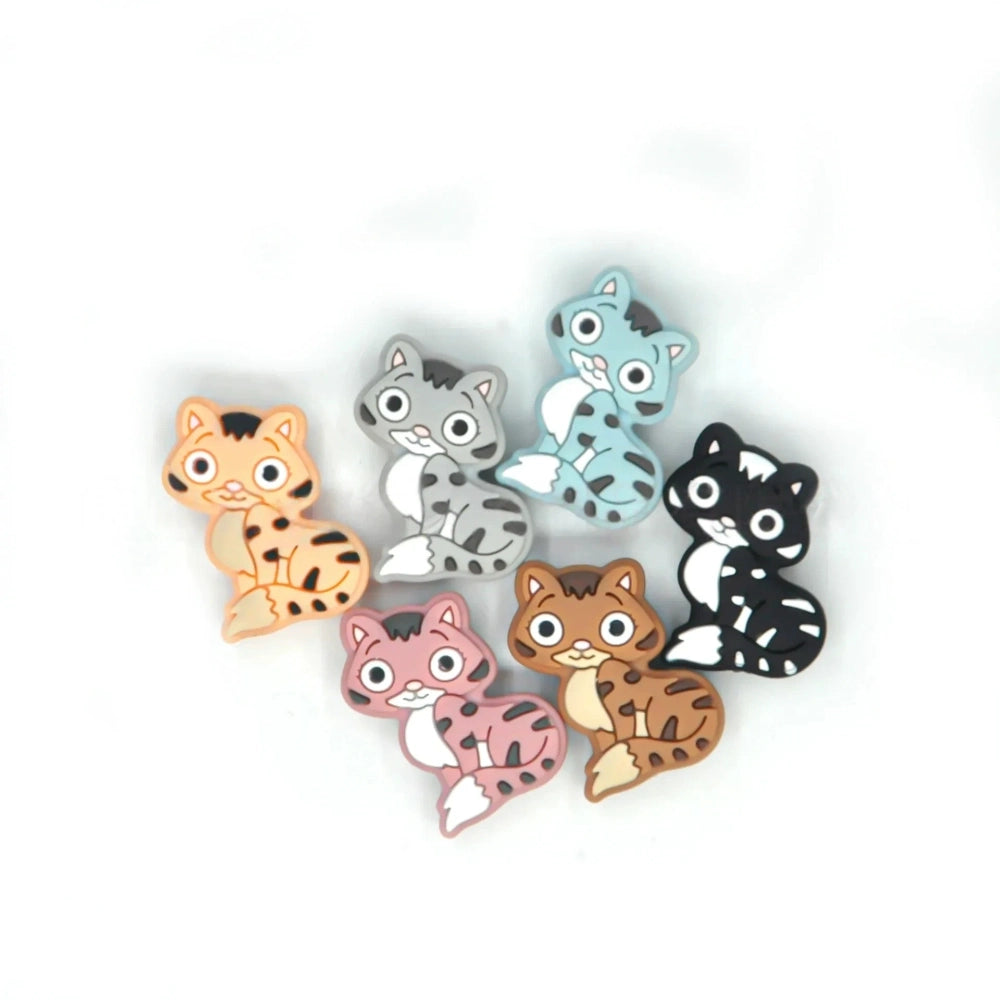 Set of 6 cartoon kitten cat silicone focal beads in orange, gray, blue, pink, brown, and black colorways with stripe tabby pattern detail on white background
