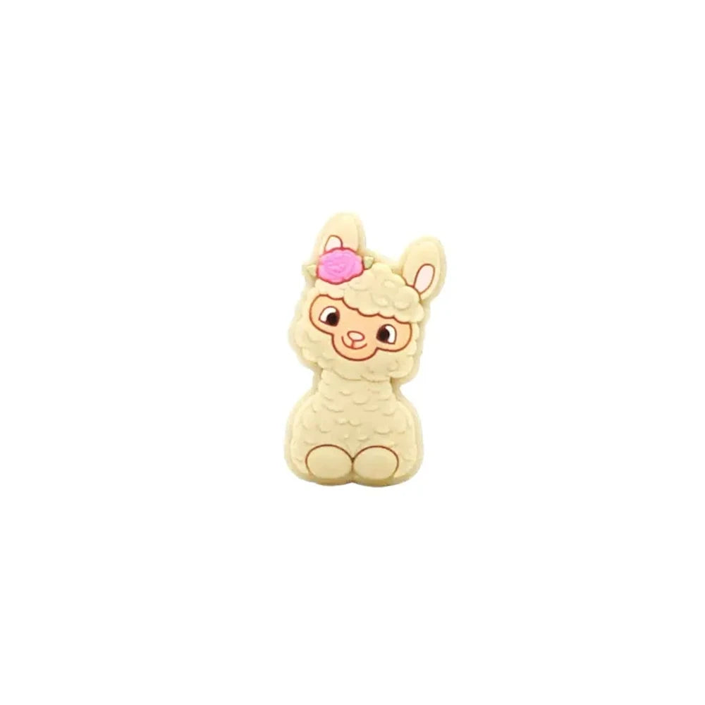 Ten colorful silicone llama alpaca focal beads in white, pink, light pink, cream, peach, green, gray, yellow, blue, and dark brown, displayed in two rows on a white background. - Creamy White