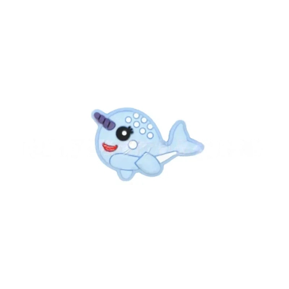 Set of 5 kawaii narwhal silicone focal beads in teal, mint, pink, light blue, gray, and dark gray, displayed on a miniature white bench with blue background. - 3