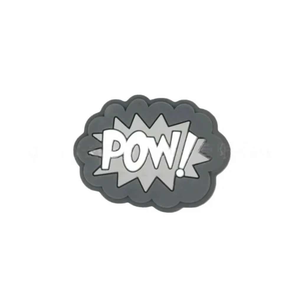 Colorful POW, BOOM, and ZAP superhero comic book silicone focal beads in blue, yellow, and light blue displayed on a white shell dish, perfect for beadable pens, keychains, and badge reels. - 3