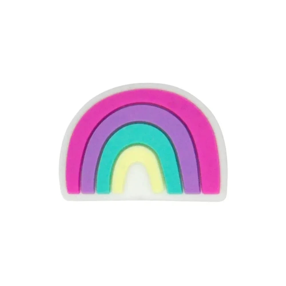 Five colorful silicone rainbow arch focal beads in various color combinations including blue-gray, multicolor, dark-mint, boho pink, and pink-teal, displayed on a wooden slice with pine cones on a star-patterned surface. - Purple-Red