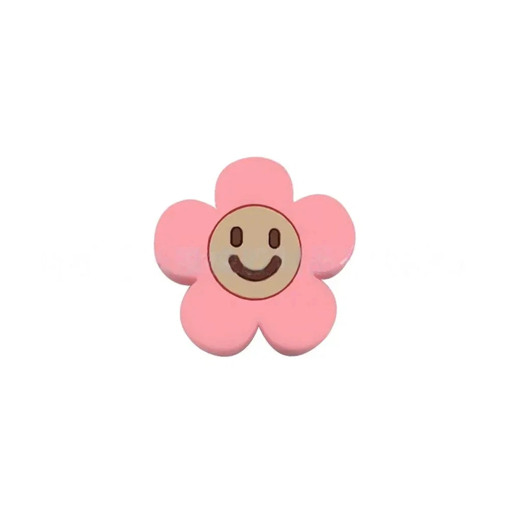10 colorful smiley face daisy flower silicone focal beads in white, yellow, mustard, teal, sage, pink, light pink, lavender, purple, and hot pink on a tan background. - Candy Pink