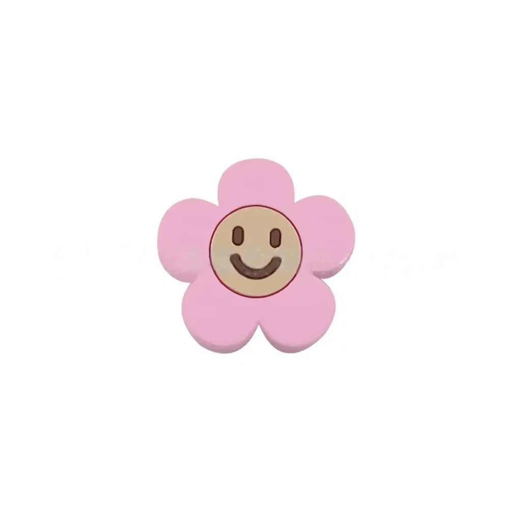 10 colorful smiley face daisy flower silicone focal beads in white, yellow, mustard, teal, sage, pink, light pink, lavender, purple, and hot pink on a tan background. - Light Pink