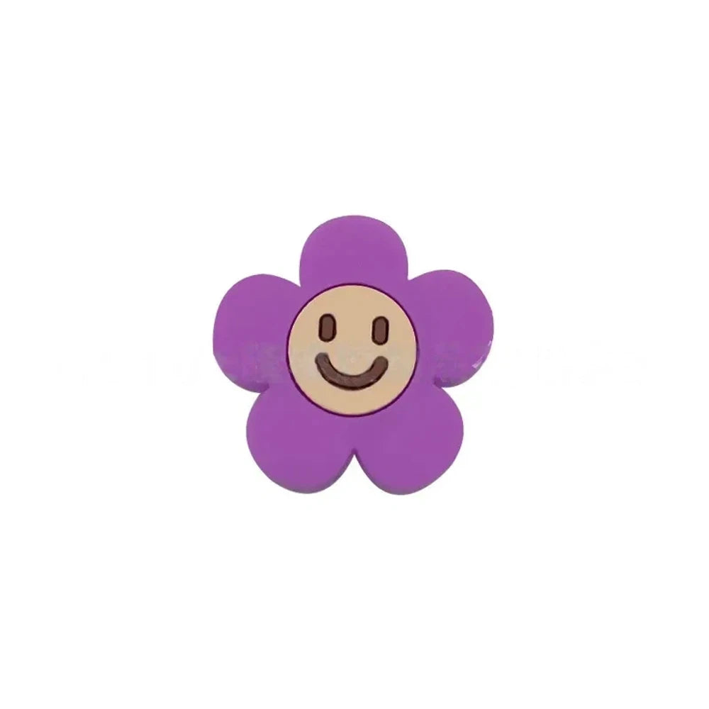 10 colorful smiley face daisy flower silicone focal beads in white, yellow, mustard, teal, sage, pink, light pink, lavender, purple, and hot pink on a tan background. - Purple