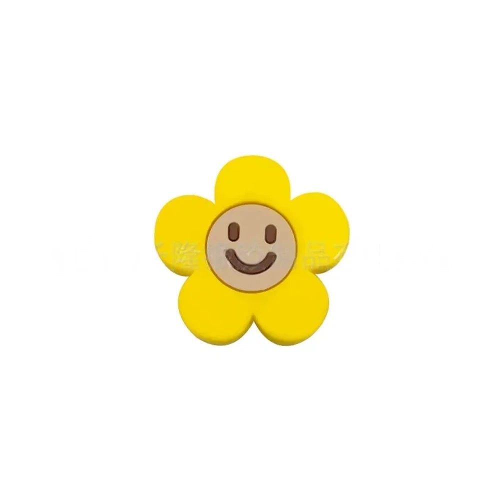 10 colorful smiley face daisy flower silicone focal beads in white, yellow, mustard, teal, sage, pink, light pink, lavender, purple, and hot pink on a tan background. - Yellow