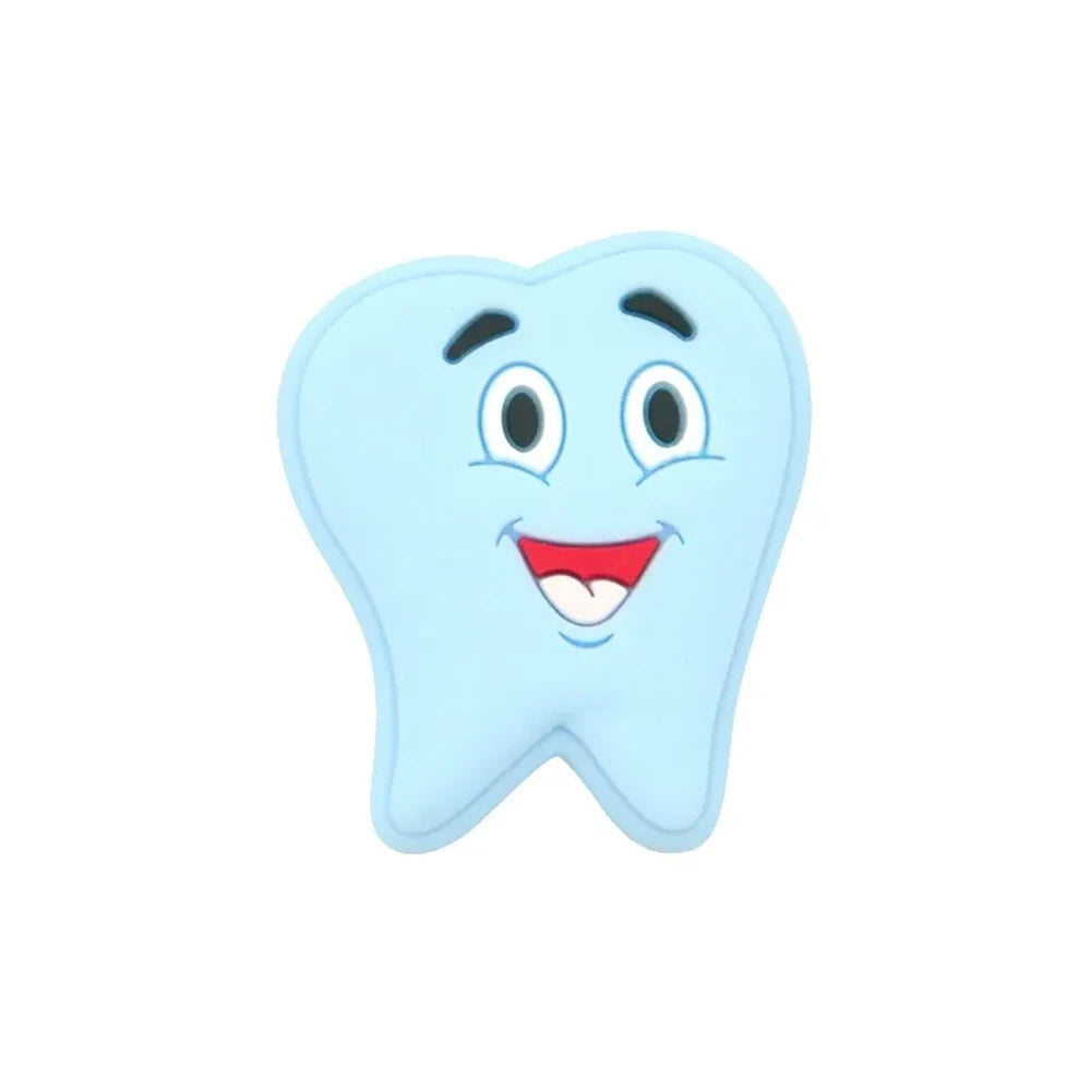 Assorted pastel smiling tooth shaped silicone focal beads in white, pink, blue, green, and gray with cartoon faces, strung on cord and displayed in a white tray on a blue background. - Light Blue