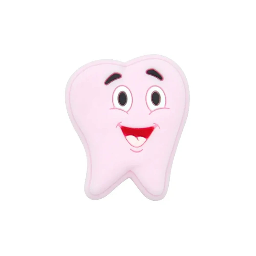 Assorted pastel smiling tooth shaped silicone focal beads in white, pink, blue, green, and gray with cartoon faces, strung on cord and displayed in a white tray on a blue background. - Light Pink