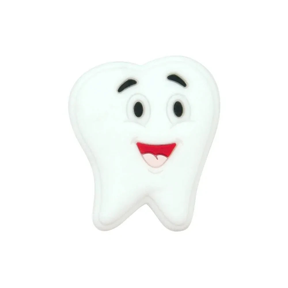 Assorted pastel smiling tooth shaped silicone focal beads in white, pink, blue, green, and gray with cartoon faces, strung on cord and displayed in a white tray on a blue background. - White