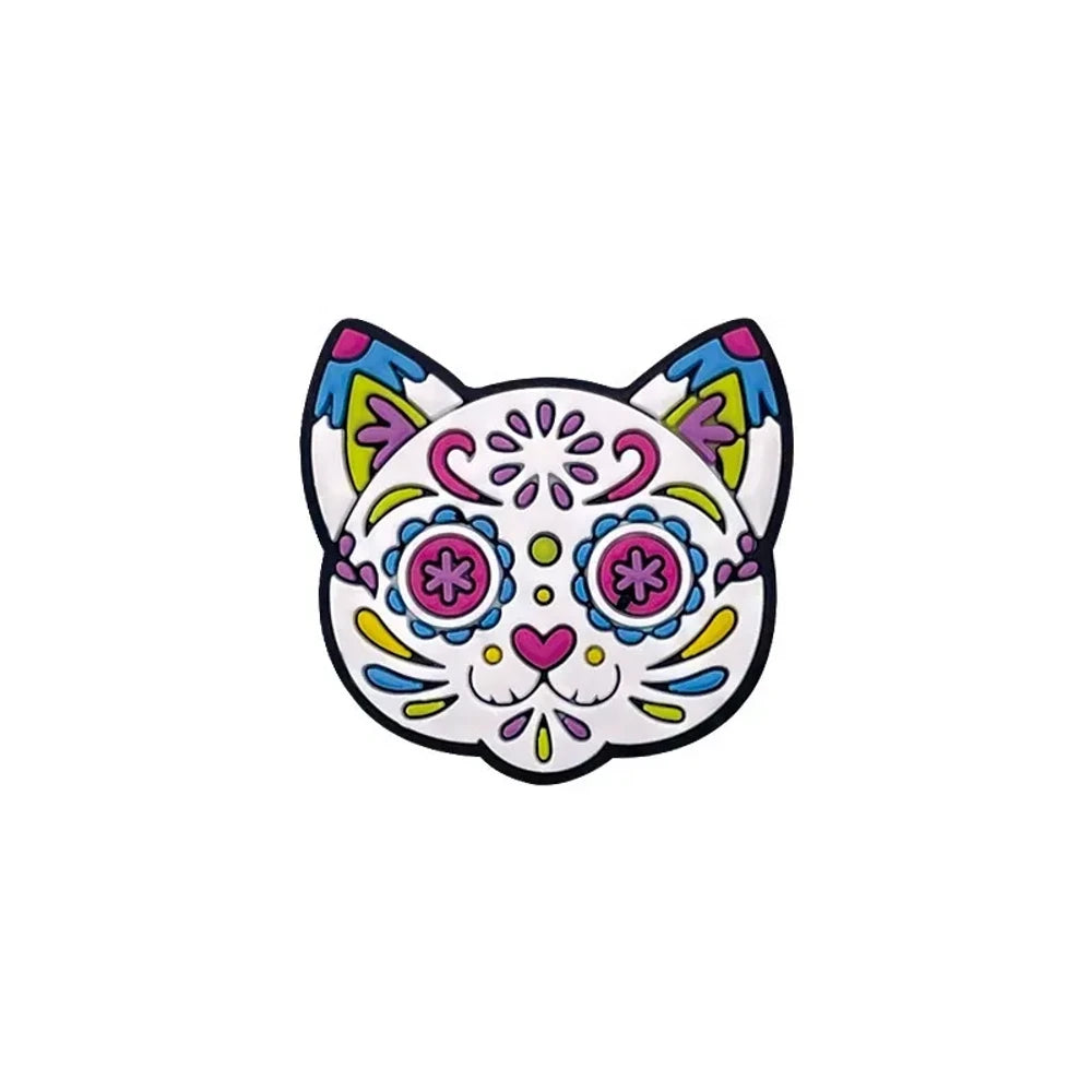 Sugar skull cat silicone focal beads in colorful Day of the Dead floral design, shown assembled on beaded keychains with pink, blue, tan, and natural wood beads on a pink background. - Cat