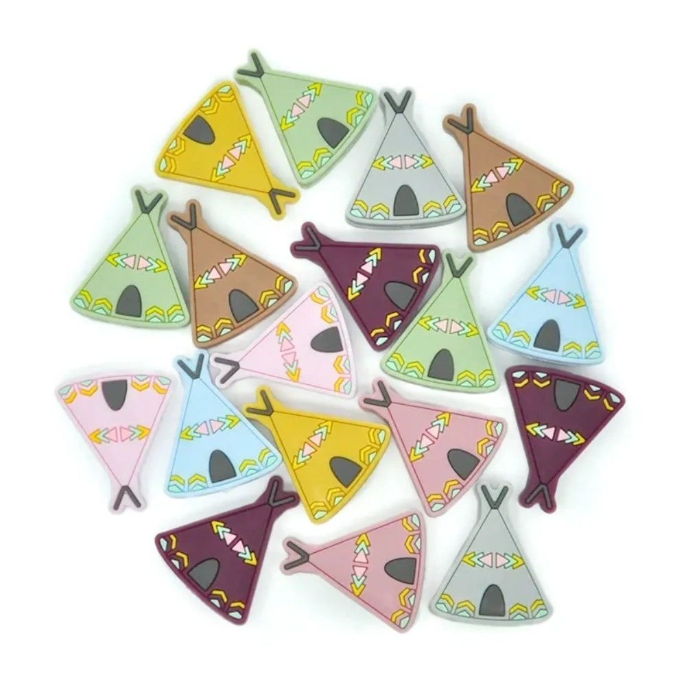 Assorted colorful silicone teepee flatback focal beads in pink, purple, mustard, sage, gray, blue, and brown with tribal arrow decorations, spread on white background. - Random Mixed