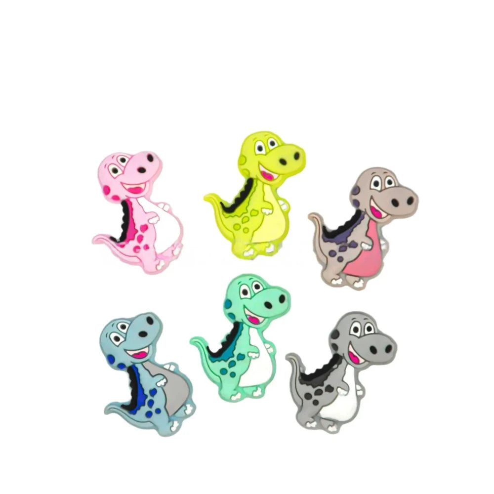 Set of 6 colorful cartoon T-Rex dinosaur silicone focal beads in pink, yellow-green, gray, blue-gray, mint green, and dark gray for DIY jewelry making and beadable pens.