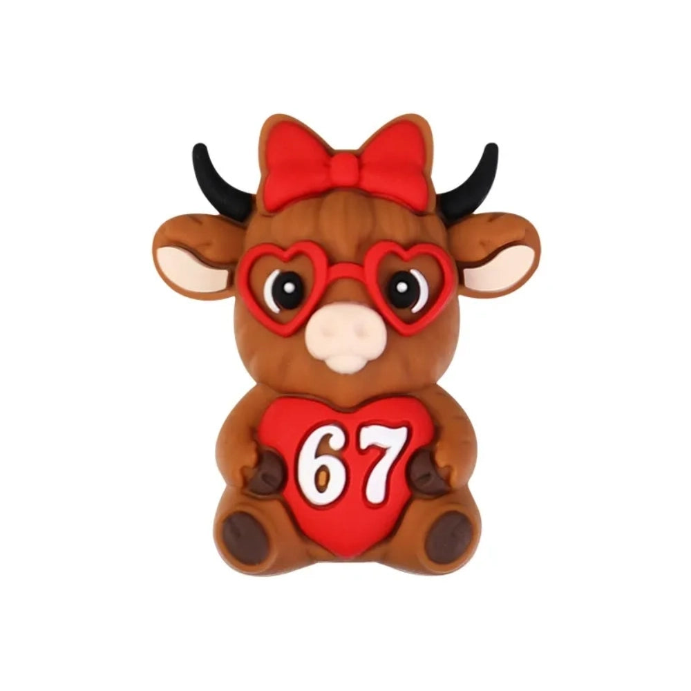 Assorted Valentine's Day silicone focal beads featuring teddy bears holding 67 hearts, highland cows with red bows, heart-shaped sunglasses, gnomes, and SIX SEVEN heart beads in red and pink tones - Cow