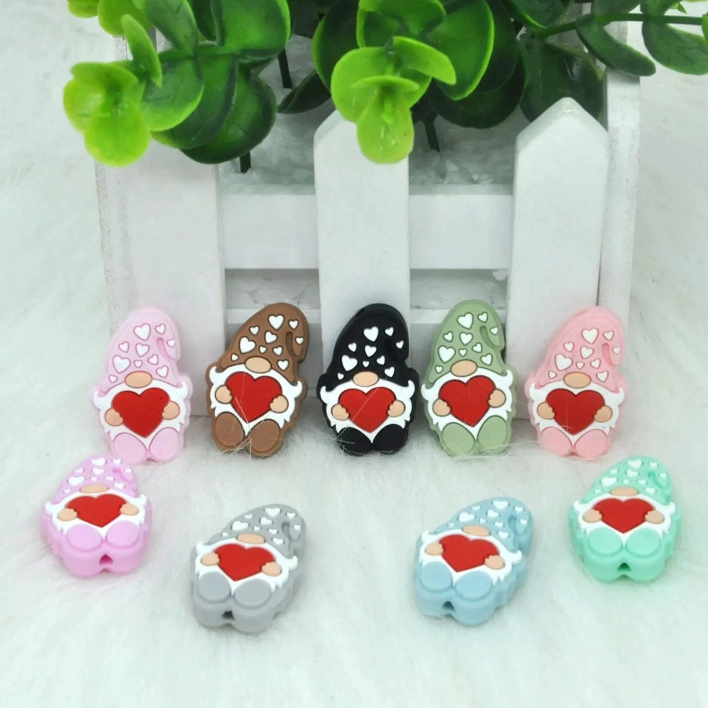 Assorted color Valentine gnome silicone focal beads holding red hearts, available in pink, brown, black, green, lavender, gray, blue, and mint, shown from front and back angles.