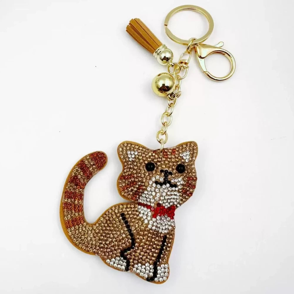 Black and white cat-shaped pave rhinestone fancy bead charms with gold-tone chain, tassels, and bow details. - 1