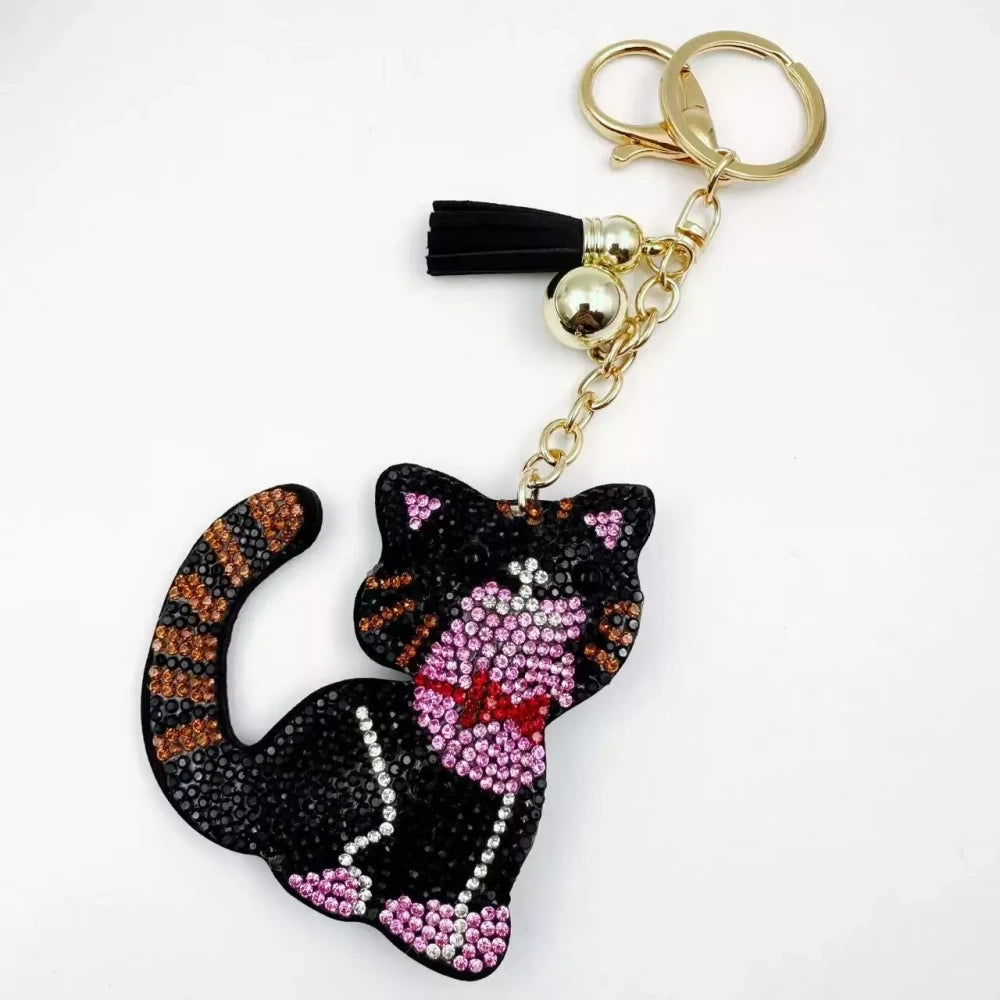 Black and white cat-shaped pave rhinestone fancy bead charms with gold-tone chain, tassels, and bow details. - 2