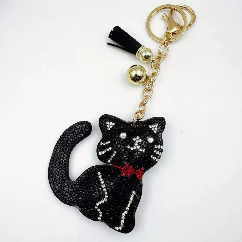 Black and white cat-shaped pave rhinestone fancy bead charms with gold-tone chain, tassels, and bow details. - 6