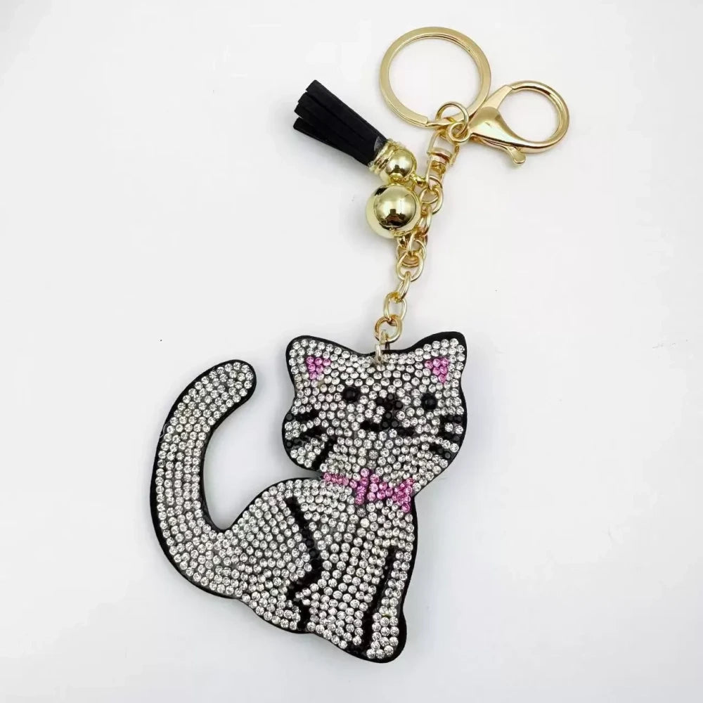Black and white cat-shaped pave rhinestone fancy bead charms with gold-tone chain, tassels, and bow details. - 7