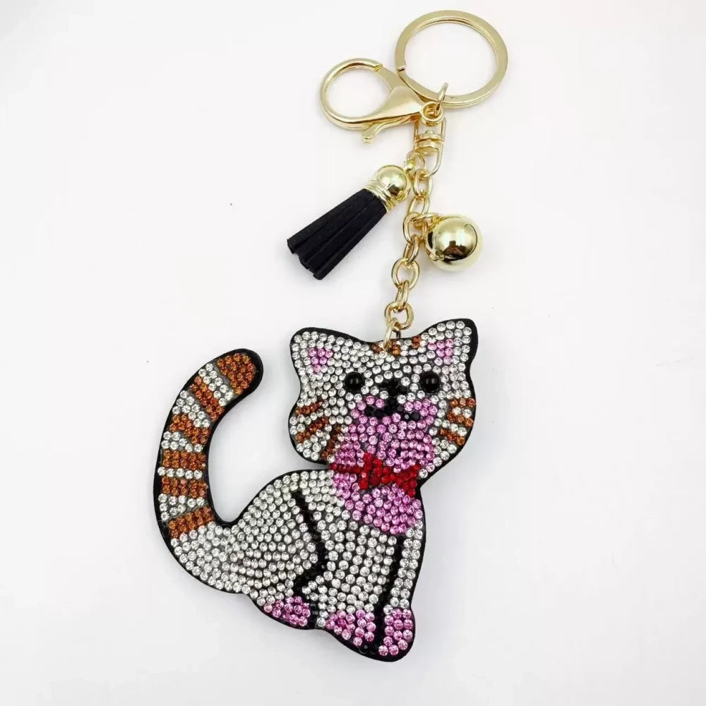 Black and white cat-shaped pave rhinestone fancy bead charms with gold-tone chain, tassels, and bow details. - 8