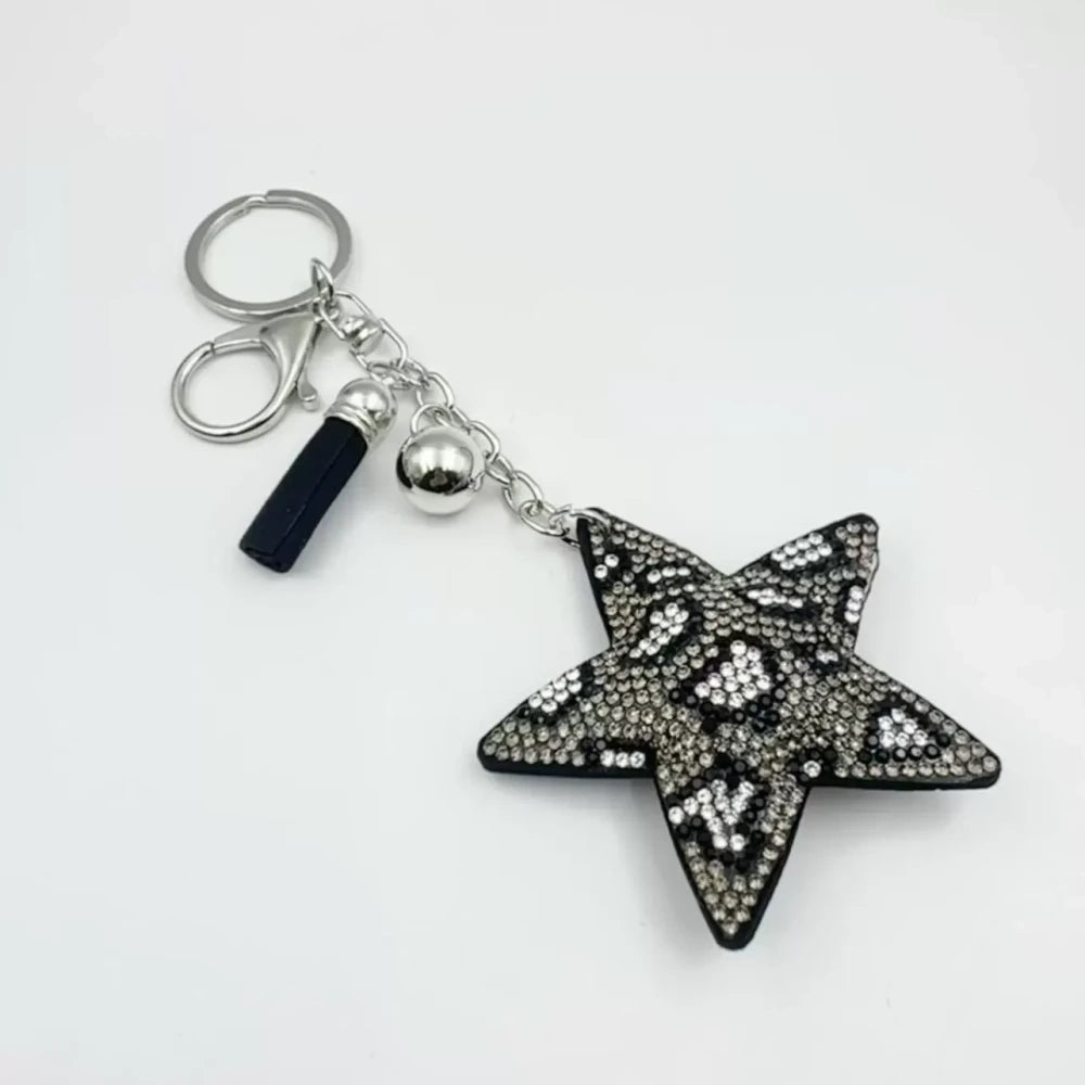 Five star-shaped leopard print rhinestone resin fancy beads in black, red, gold, and silver tones displayed as keychain-style craft pieces. - Gray