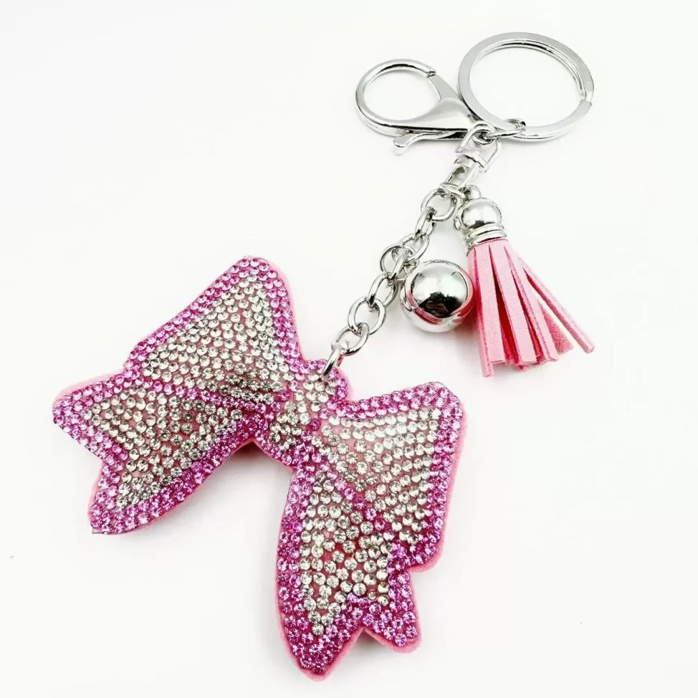 Pink and black bling bow rhinestone fancy beads with tassels, bell charms, and silver keychain hardware - Pink