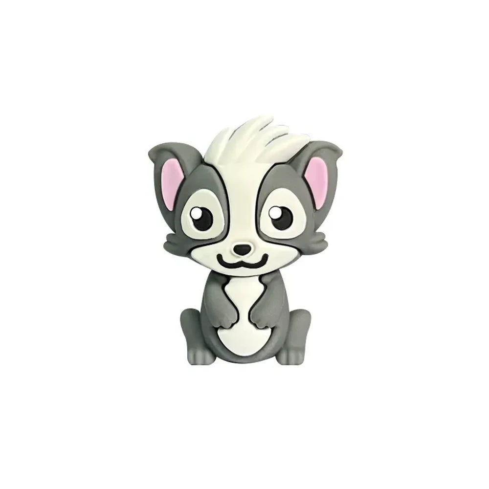 Three cute cartoon skunk silicone focal beads in gray, dark gray, and black colorways displayed on beadable pens with decorative silicone beads on a woven mat background. - Dark Gray