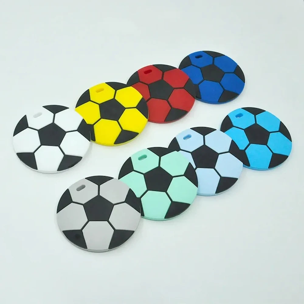 Eight soccer ball silicone flatback focal beads in assorted colors including black and white, yellow, red, blue, grey, mint, light blue, and sky blue, each with a small hole for crafting.