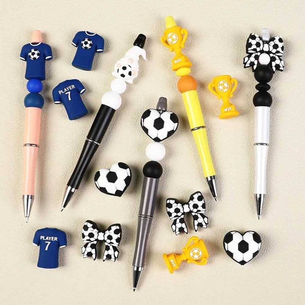 Set of 12 soccer-themed 3D silicone focal beads including MVP trophy, player jersey, football bow, gnome, heart football, and blue shirt designs for DIY crafts. - Random Mixed