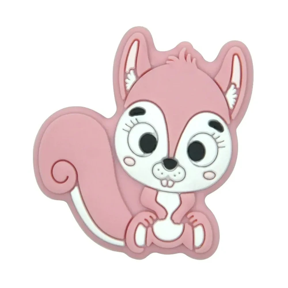 Ten colorful cartoon squirrel silicone focal beads in beige, pink, rose, mauve, brown, blue, green, gray, peach, and yellow arranged in two rows on a white background. - Pink