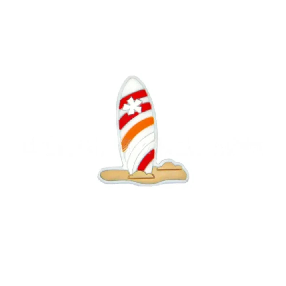 Colorful striped surfboard silicone focal beads in blue and white with flower detail, displayed in a white shell-shaped dish on a light blue background. - White