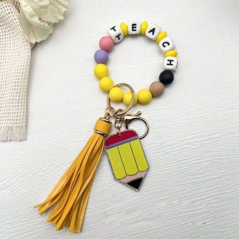 Colorful TEACH letter printed silicone bead bracelet keychains with pencil charms and tassel accents in mint, pink, rainbow, and yellow color combinations - 5