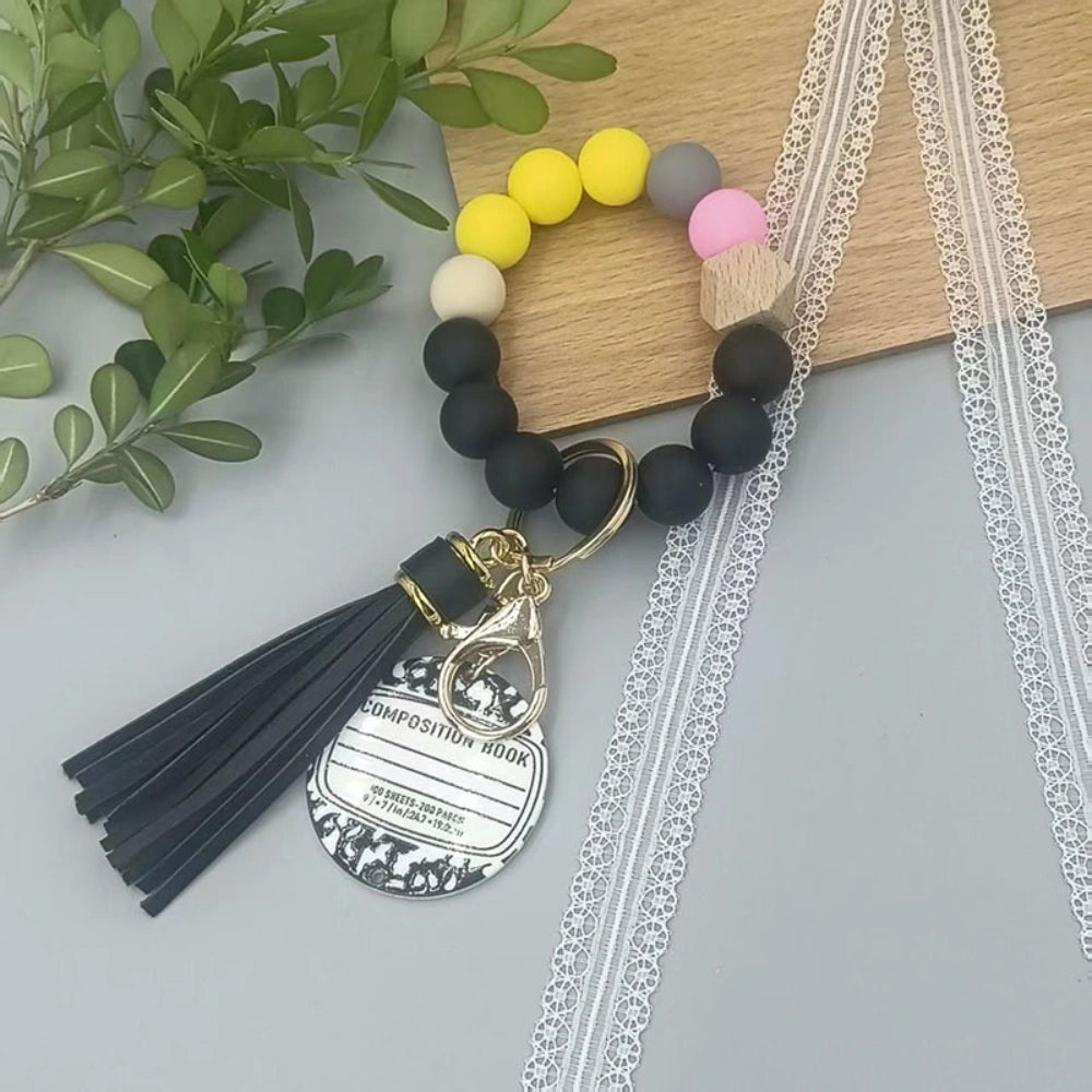 Colorful TEACH letter printed silicone bead bracelet keychains with pencil charms and tassel accents in mint, pink, rainbow, and yellow color combinations - 6