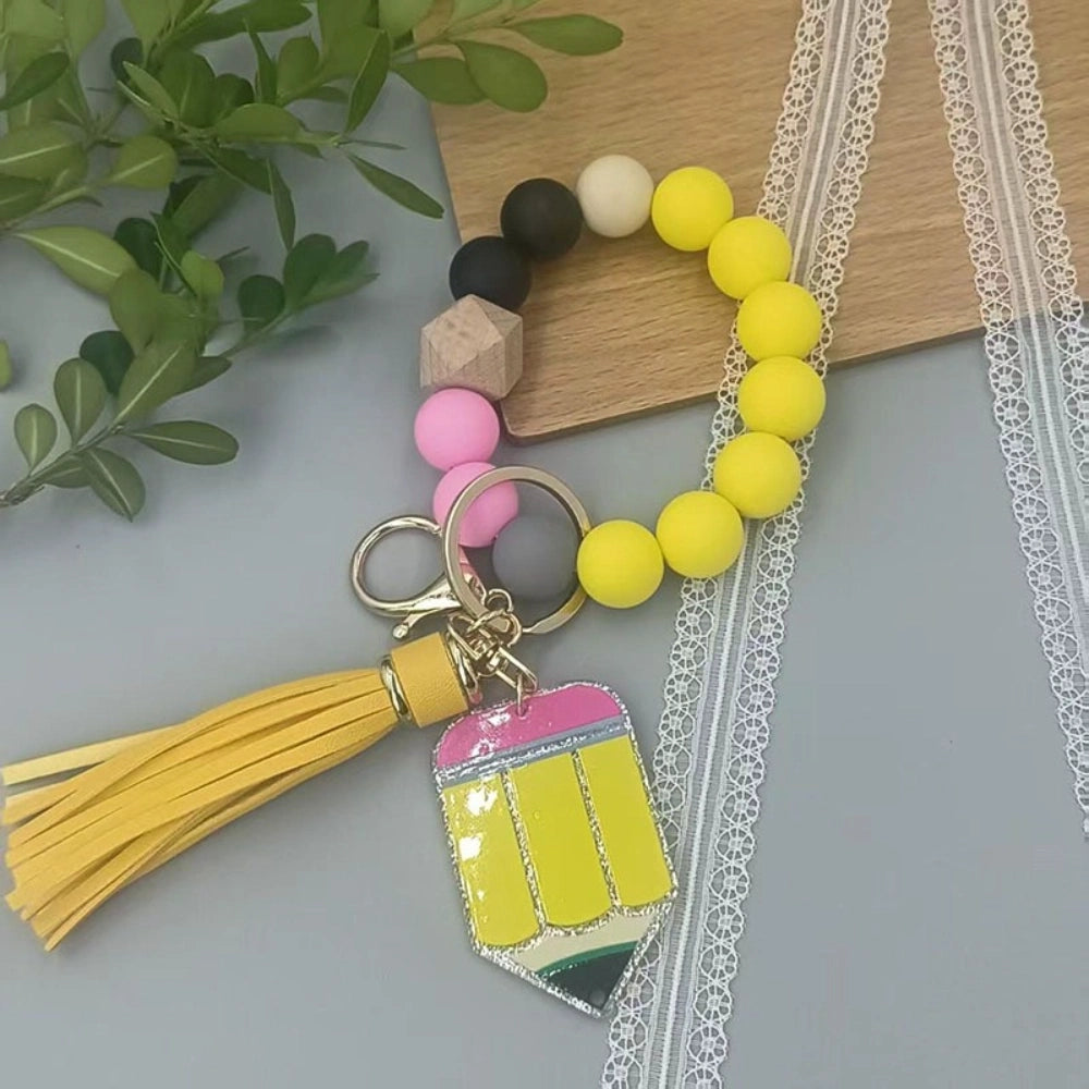 Colorful TEACH letter printed silicone bead bracelet keychains with pencil charms and tassel accents in mint, pink, rainbow, and yellow color combinations - 7