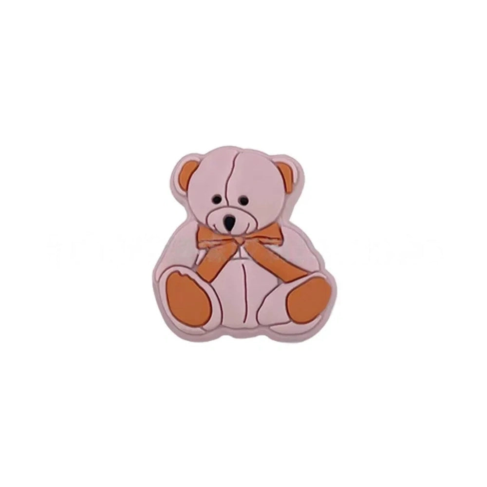 Six teddy bear silicone focal beads in white, tan, pink, mint, blue, and gray, each with a bow tie accent, displayed on a white background for DIY craft projects. - Pink