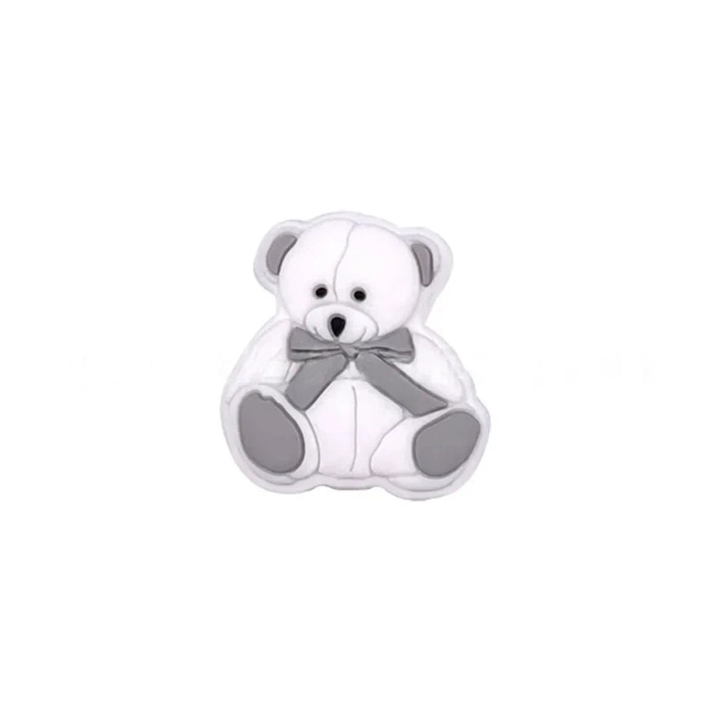 Six teddy bear silicone focal beads in white, tan, pink, mint, blue, and gray, each with a bow tie accent, displayed on a white background for DIY craft projects. - White