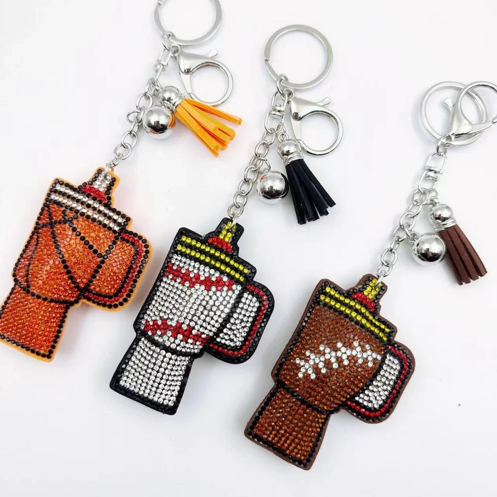 Three moka pot coffee maker rhinestone fancy beads in orange, white, and brown with tassels and silver keychain clasps. - Random Mixed
