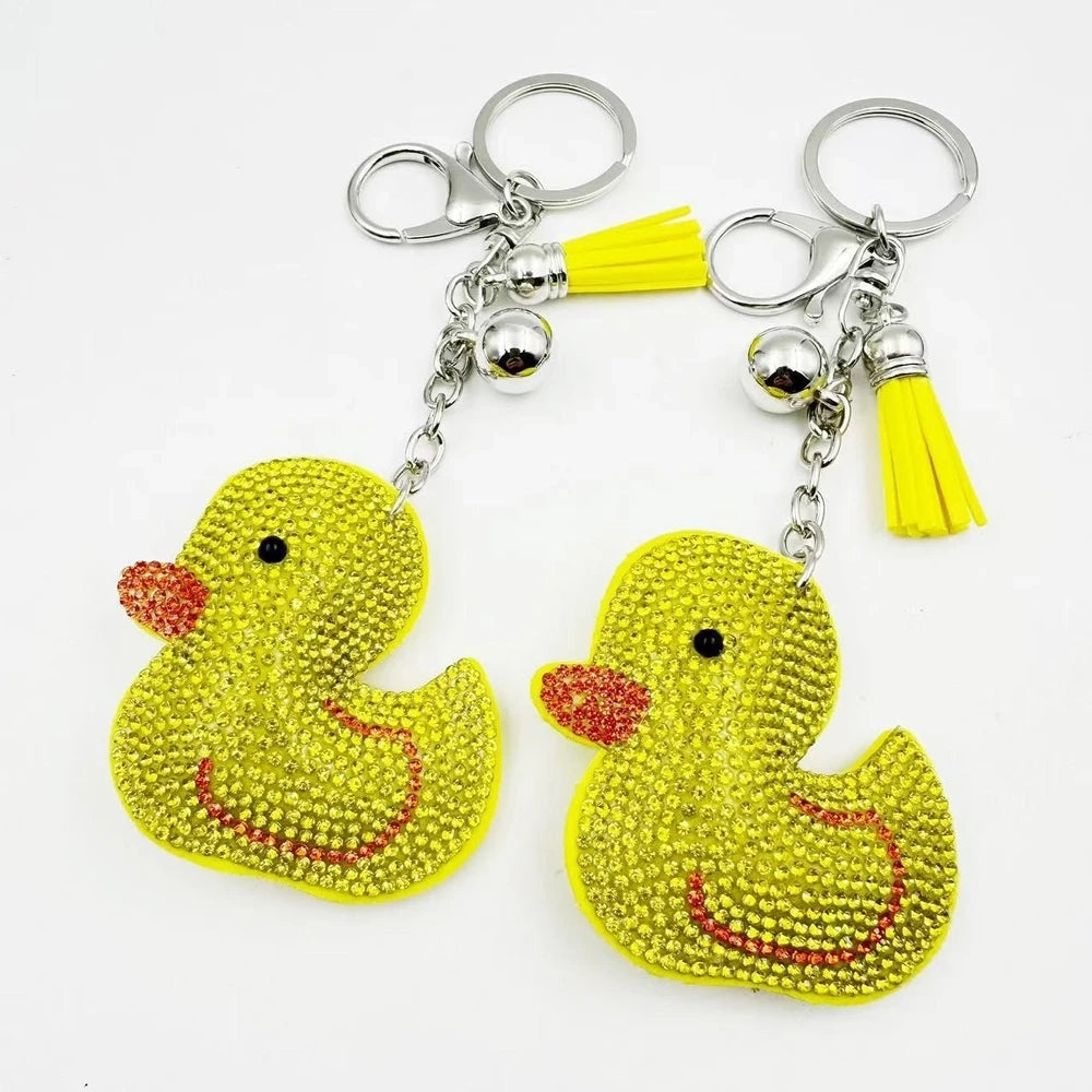 Bright yellow duck rhinestone fancy bead charms with silver keychain hardware, tassels, and bell accents