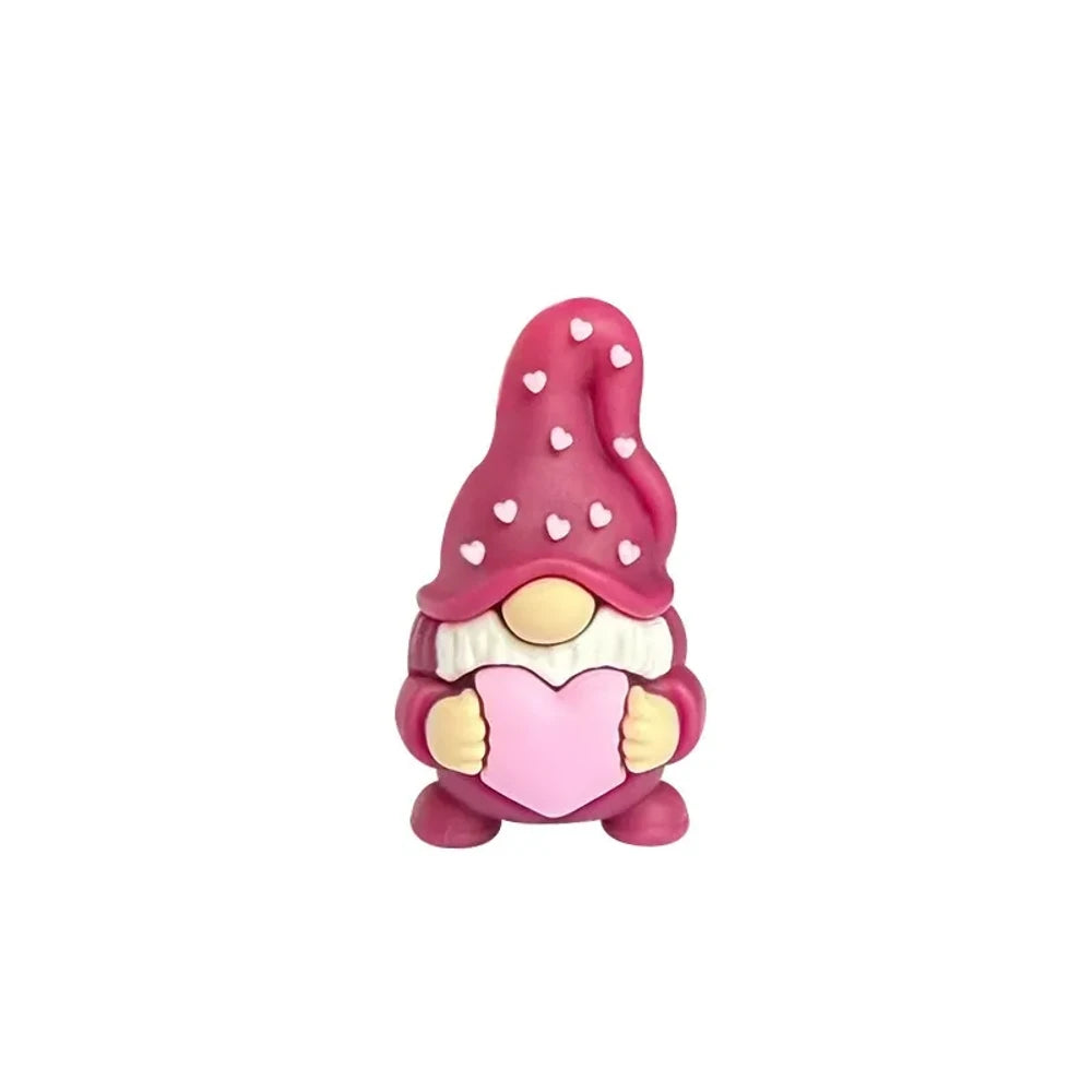 Assorted Valentine gnome silicone focal beads in red, pink, gray, and burgundy holding pink hearts, displayed on a white cloud tray with beadable pens below. - Burgundy