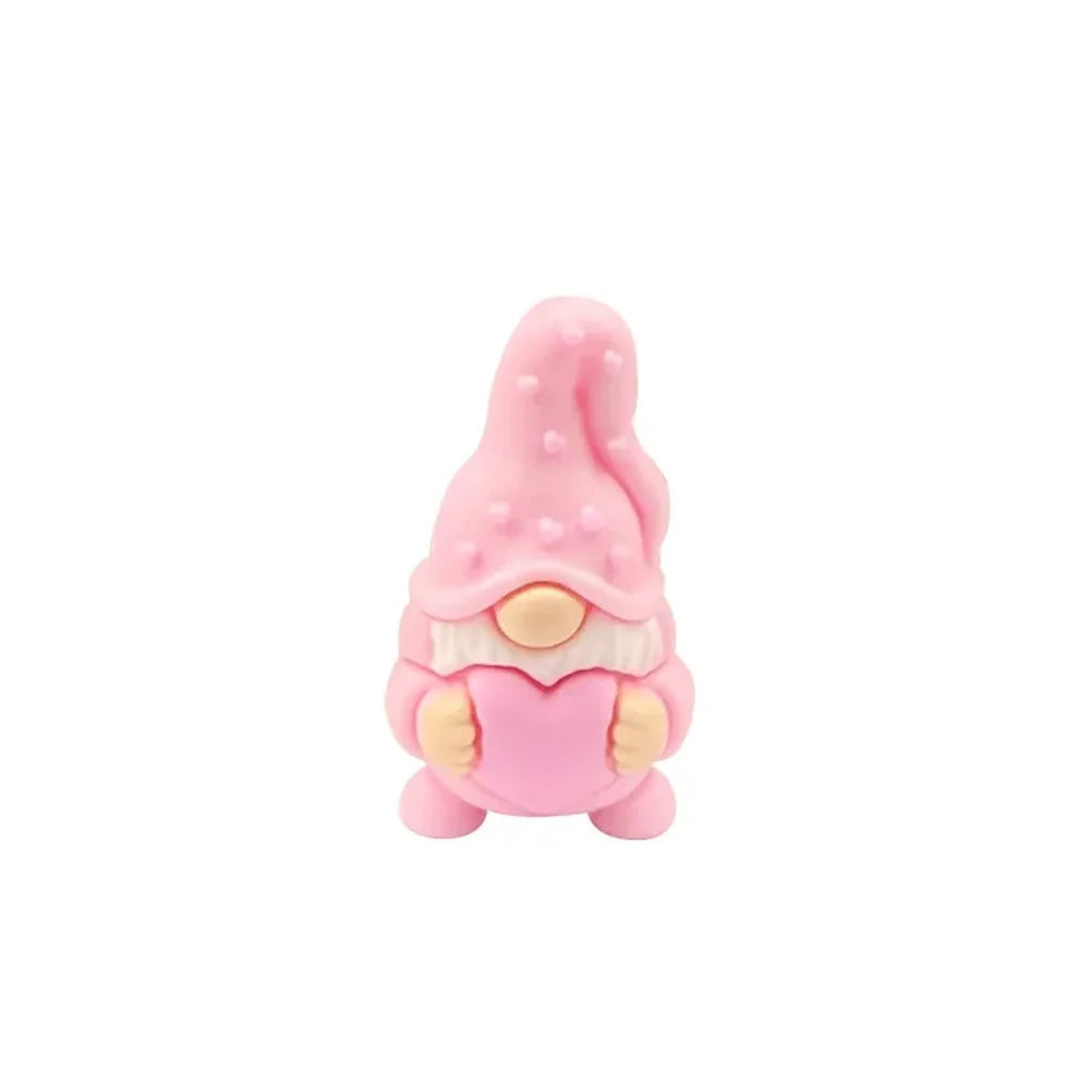 Assorted Valentine gnome silicone focal beads in red, pink, gray, and burgundy holding pink hearts, displayed on a white cloud tray with beadable pens below. - Pink