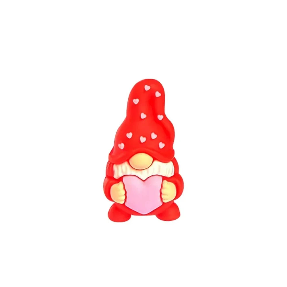 Assorted Valentine gnome silicone focal beads in red, pink, gray, and burgundy holding pink hearts, displayed on a white cloud tray with beadable pens below. - Red