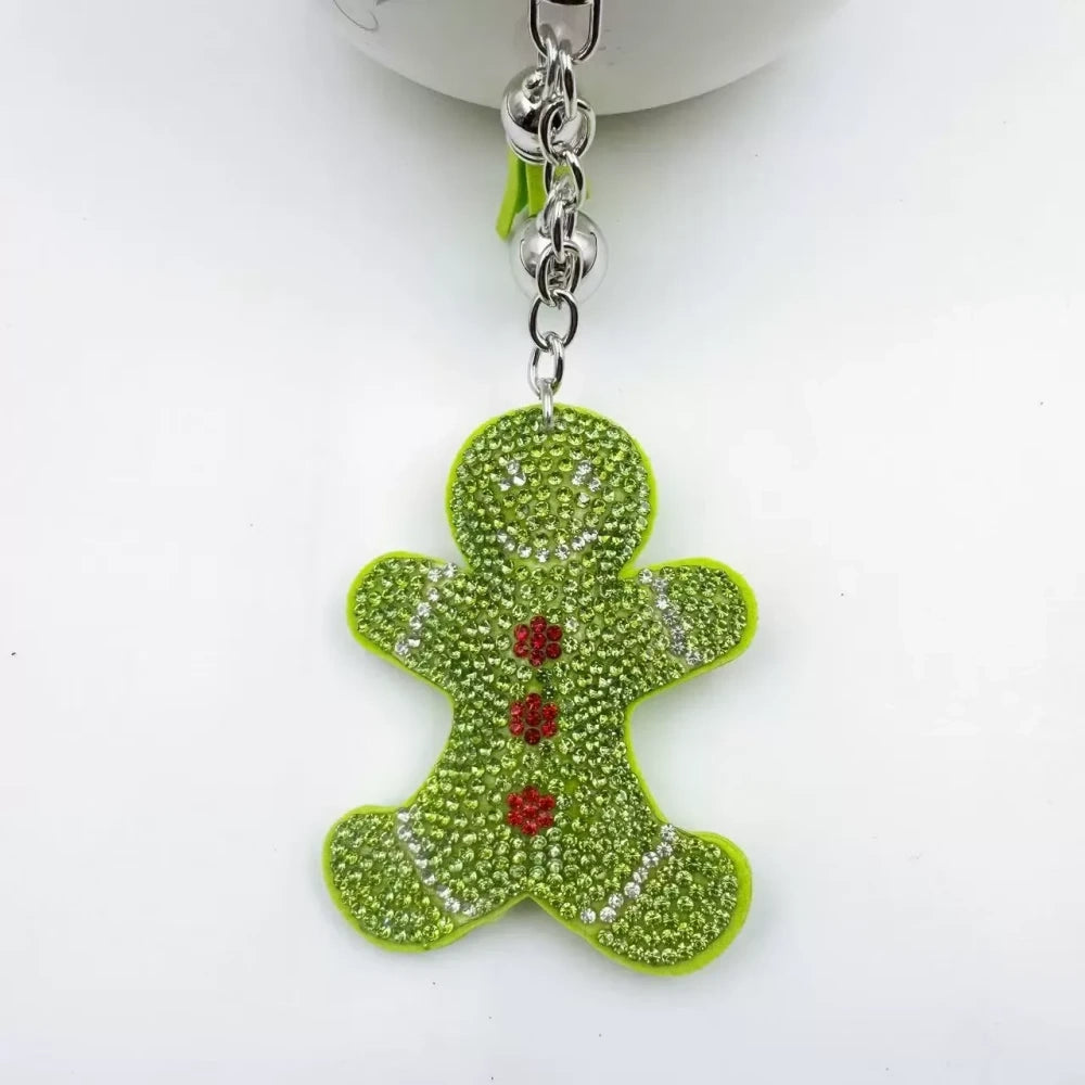 Three rhinestone gingerbread figure keychain charms in brown, pink, and orange with tassels and silver clasp rings - 3